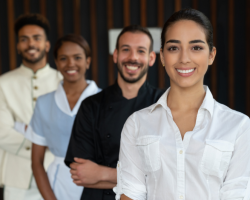 Eine Gruppe von Hotelpersonal laechelt in die Kamera